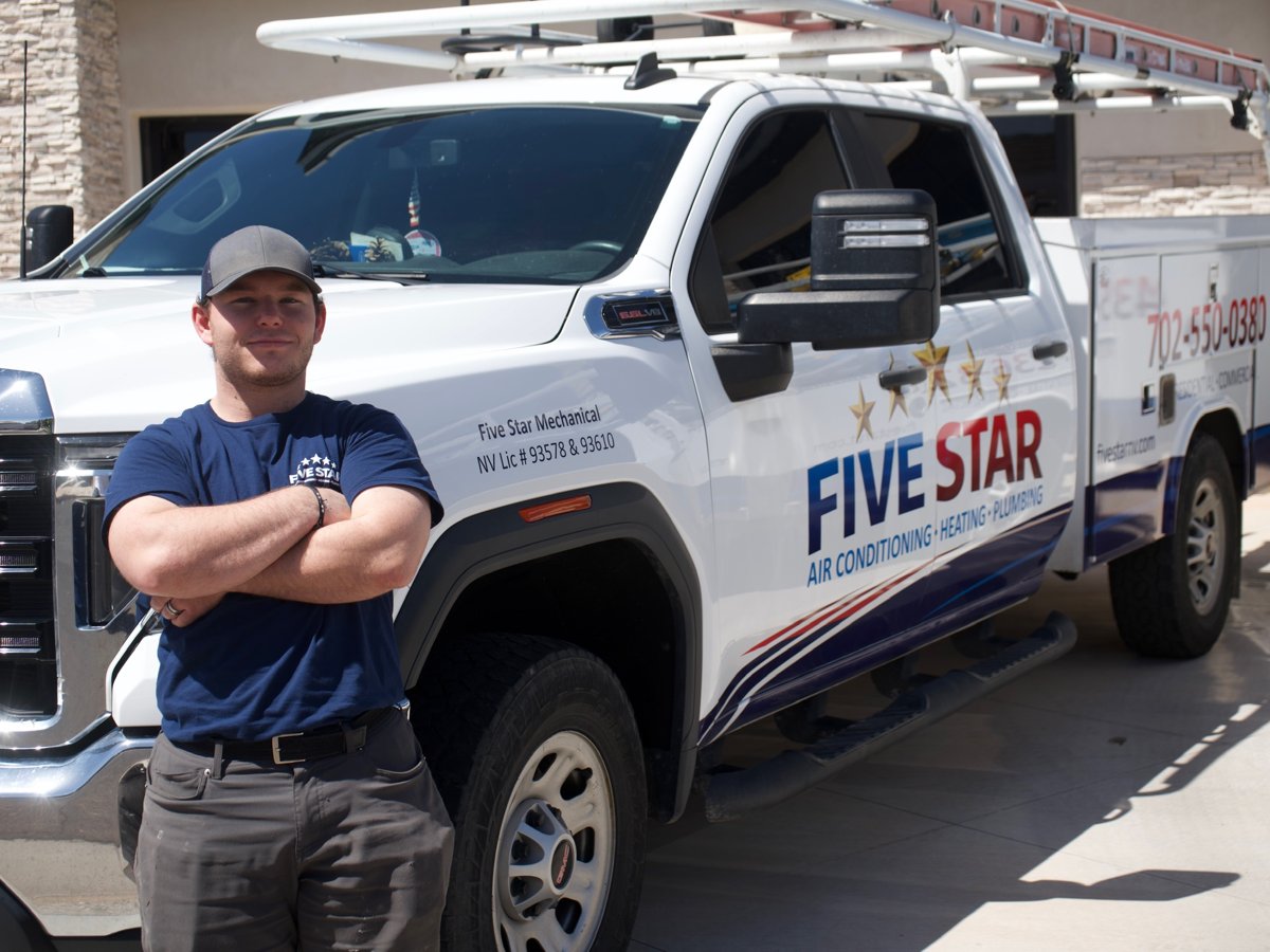 Dallin Potter standing in front of his Five Star Mechanical service truck in Las Vegas