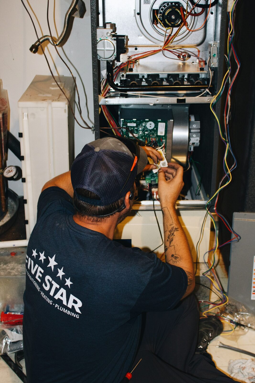 Five Star Mechanical technician servicing a furnace control board