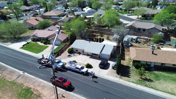 Drone aerial of a Five Star Mechanical crew swapping a rooftop AC unit with crane