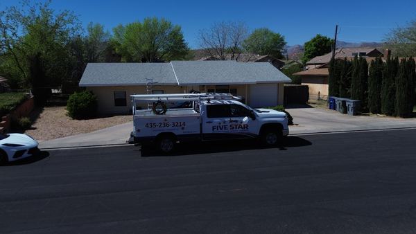 Drone aerial of a Five Star Mechanical service truck at a residential home
