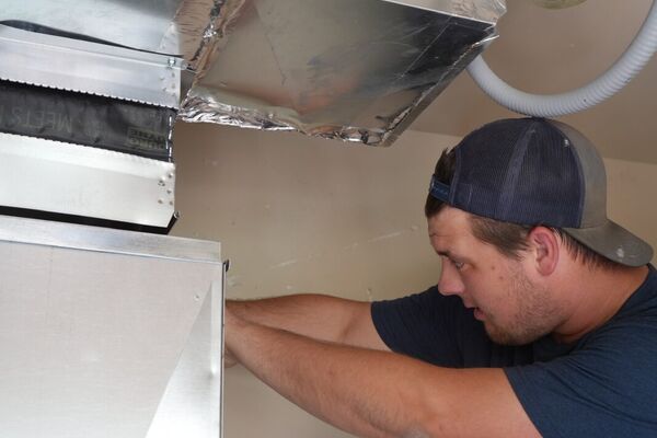 Five Star Mechanical technician installing ductwork and an air handler in Las Vegas, NV